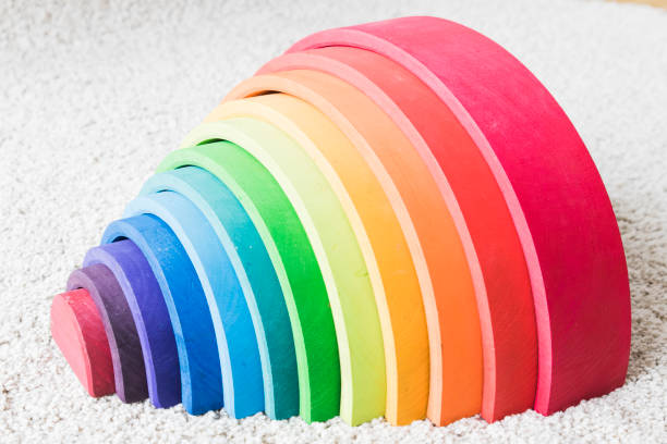 istock wooden waldorf rainbow on white carpet 936140058
