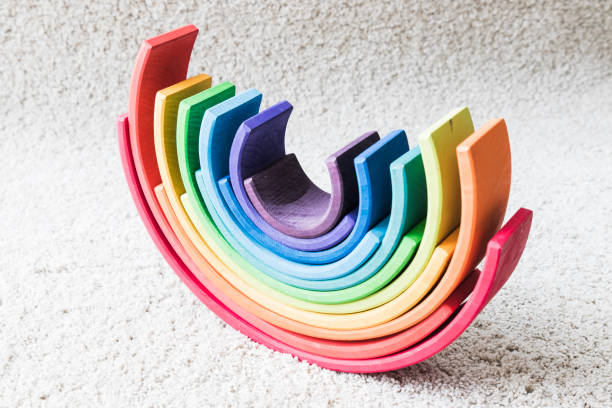istock wooden waldorf rainbow on white carpet 936140124