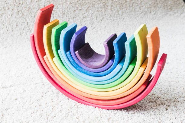 istock wooden waldorf rainbow on white carpet 936140242