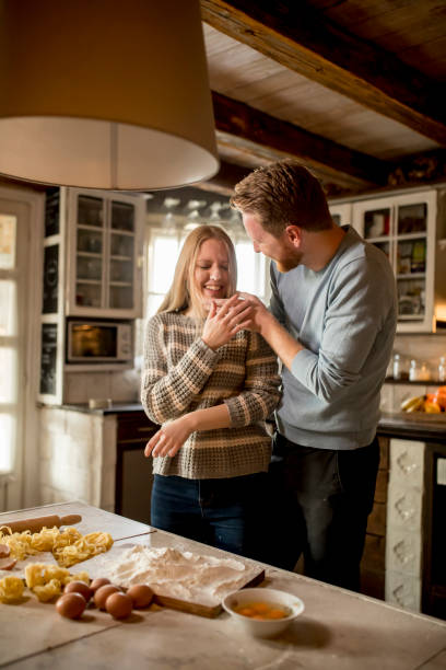 istock Loving couple preparing pasta in the kitchen 936140258