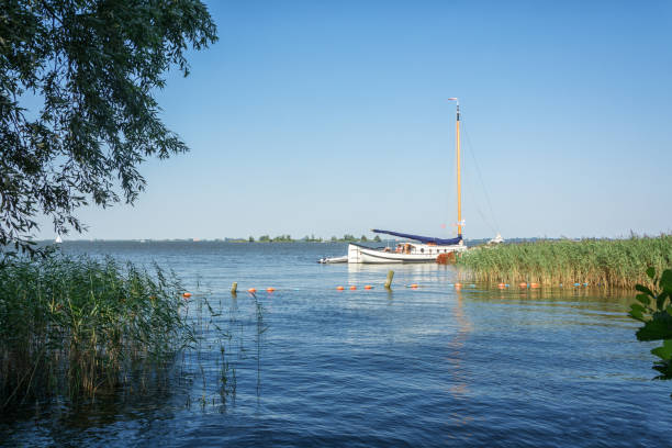 sailboat on one of the frisian lakes in the netherlands - buoy horizontal lake sailing imagens e fotografias de stock