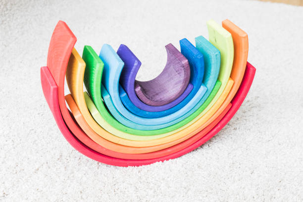 istock wooden waldorf rainbow on white carpet 936140308