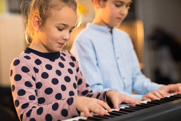 istock Brother and sister on the piano class 936140508