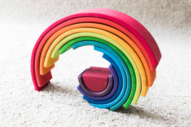 istock wooden waldorf rainbow on white carpet 936140560