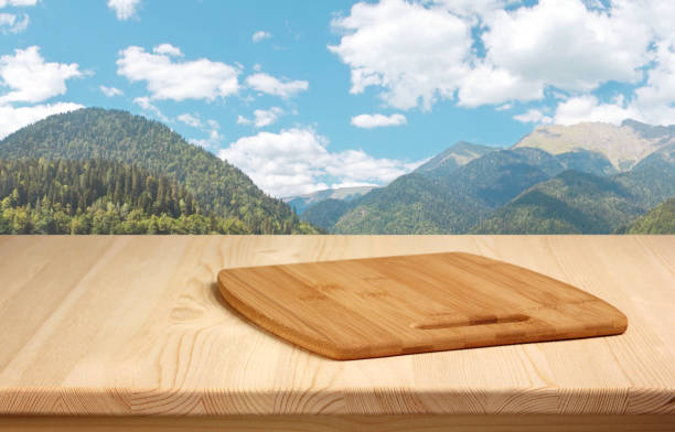 wooden table with cutting Board on a background of mountains. empty space for your product. layout.