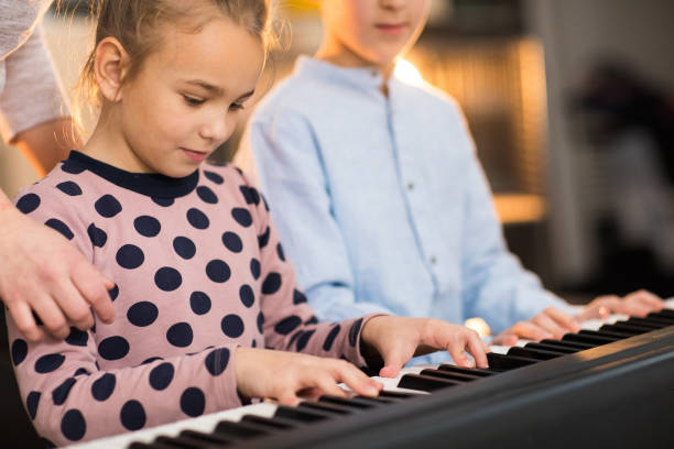 istock Brother and sister on the piano class 936140616