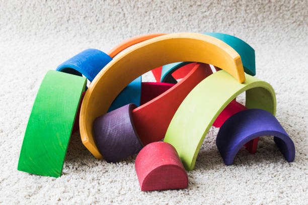 istock wooden waldorf rainbow on white carpet 936140676