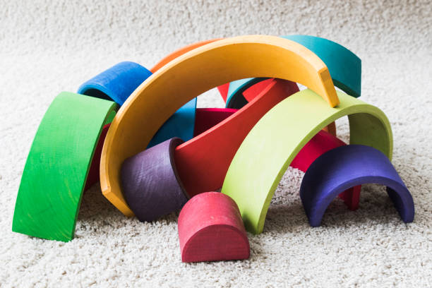 istock wooden waldorf rainbow on white carpet 936140726