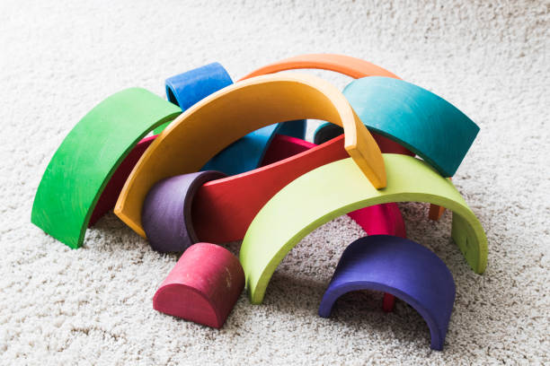 istock wooden waldorf rainbow on white carpet 936140830