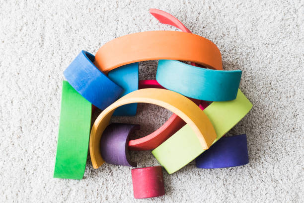 istock wooden waldorf rainbow on white carpet 936143158