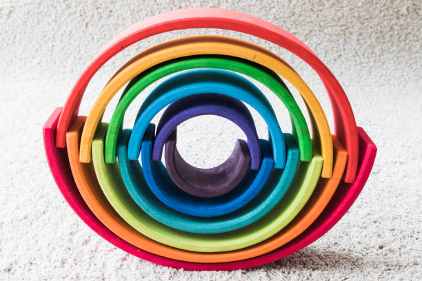 istock wooden waldorf rainbow on white carpet 936143254
