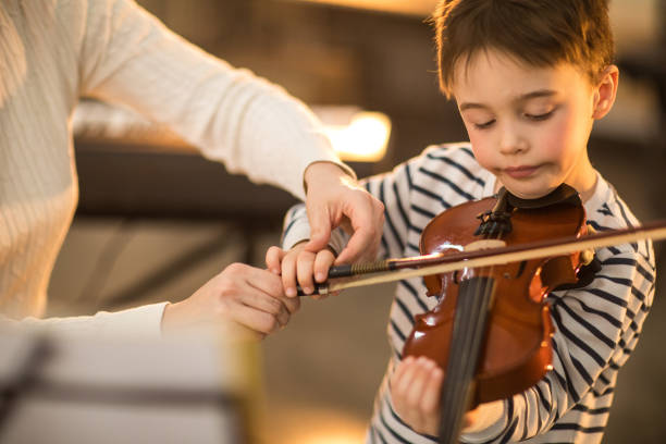 istock Little boy and his teacher on the violin class 936144874