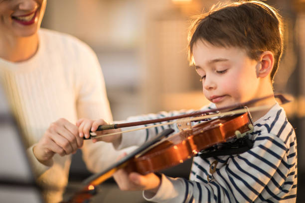 istock Little boy and his teacher on the violin class 936147056