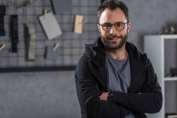 istock smiling man with glasses  looking at camera with arms crossed 936147064