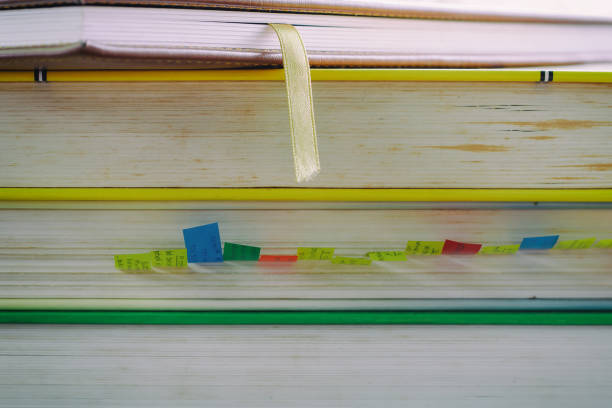 istock Stack of book on blurred natural green background 936147350