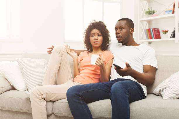 istock Surprised black couple watching TV at home 936147952