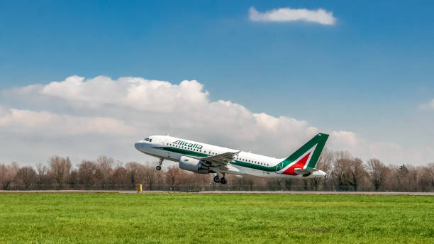 Alitalia airplane taking off on runway stock photo