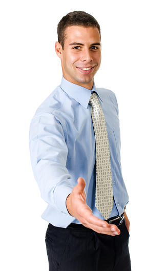 Young friendly businessman with blue shirt and tie giving hand to say hello.