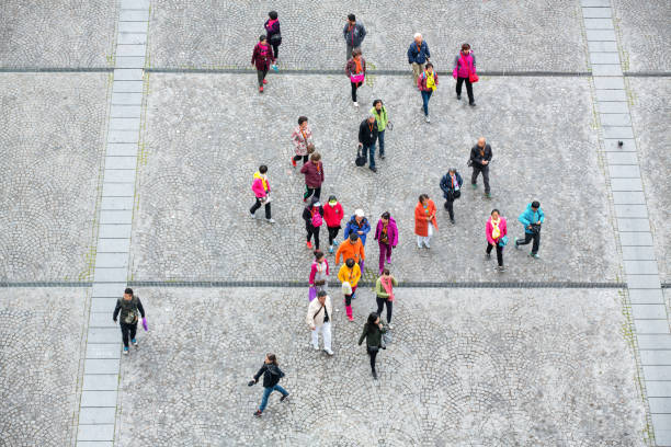 Paris, France - April 27, 2016: View from the Centre Georges Pompidou in Paris. Group of tourists in colorful clothes are crossing Place Georges Pompidou.