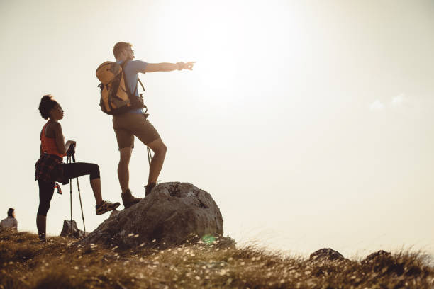 istock Small Group of People Standing on Top of Hill 936152928