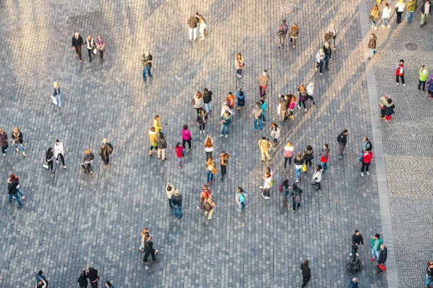 Prague, Сzech Republic - April 06, 2016: View on Old Town Square in Pargue from the Astronomical Clock Tower - tourists illuminated by the sunset light are gathering on the square.