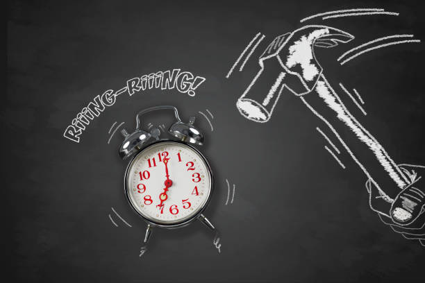 illustrated photo, with blackboard effect, representing a hand armed with a hammer that is about to destroy an alarm clock