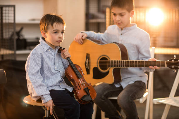 istock Boys at the music class playing together 936157168
