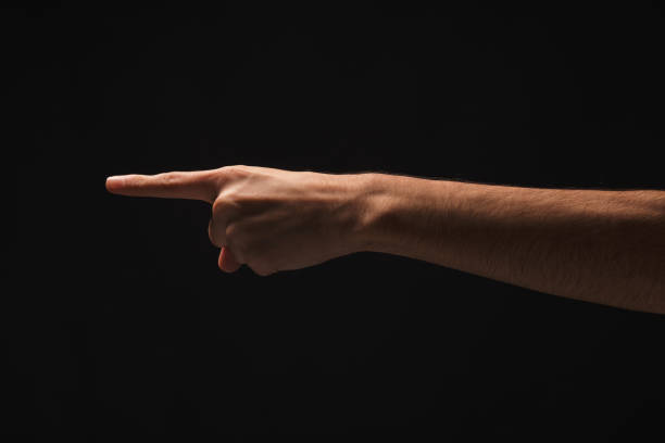 istock Hand gestures - man pointing, isolated at black 936159576