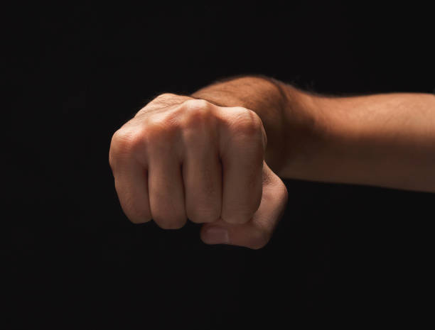 istock Male fist on black background 936159586