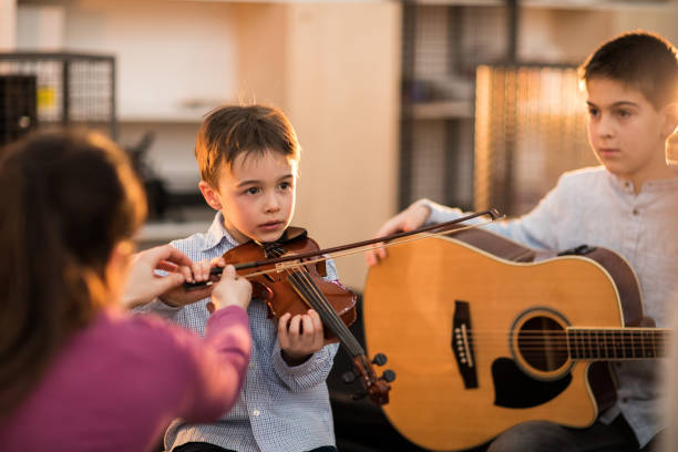 istock Boys at the music class playing together 936160174