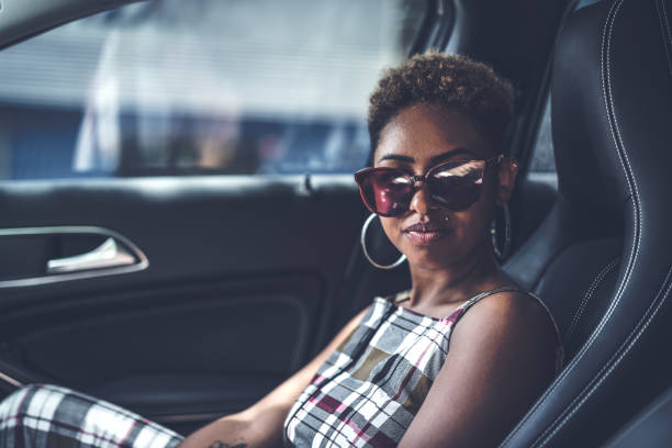 istock Sexy afro young descent woman inside a luxury car 936161826