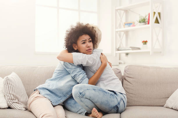 istock Three young female friends chatting at home 936162074