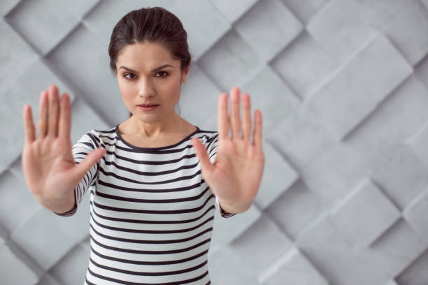 istock Smart unhappy woman standing against the wall 936166730