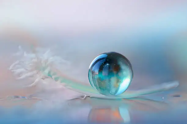 Photo of Blue marble stone and a feather