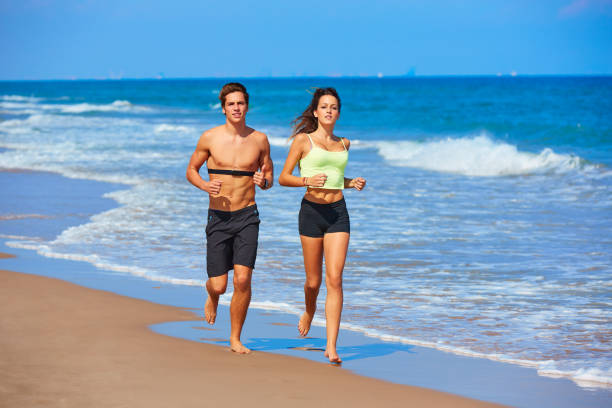 istock Couple young running in the beach in summer 936172514