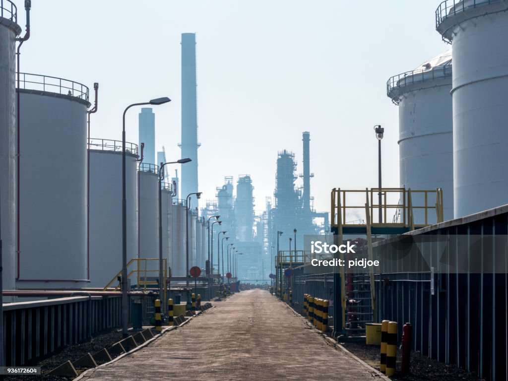 storage tanks in a row near the port of Rotterdam The Netherlands,In the back petrochemical plant Chemical Plant Stock Photo