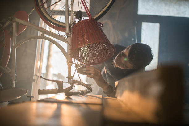 istock Man repairing bicycle in workshop 936173050