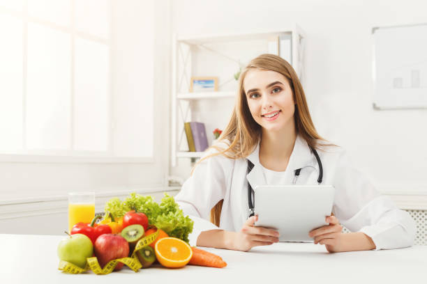 istock Female nutritionist working on digital tablet 936175472