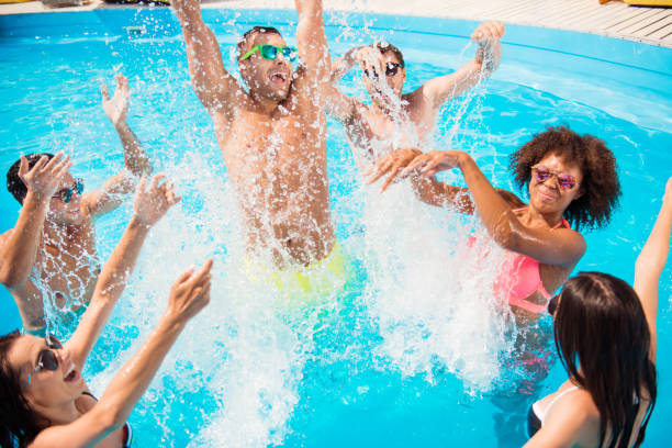 go crazy in the water! splitting and go insane! crazy tourists are enjoying at the pool sunny beach disco, splashes of water, guys jump and dabble
women, they scream and laugh - men sensuality photography high angle view imagens e fotografias de stock