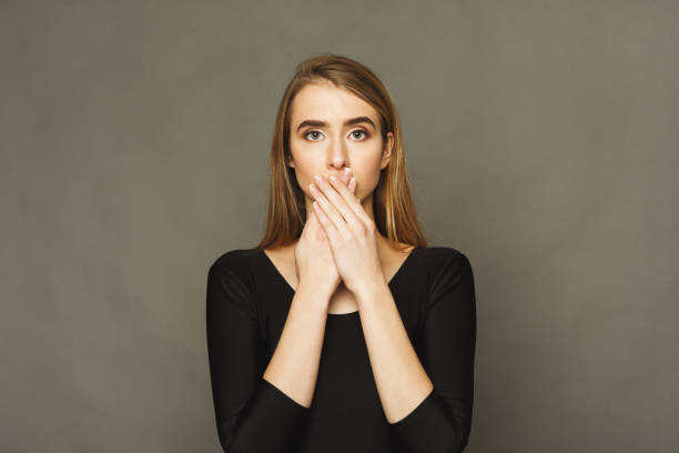 istock Confused woman puts her hands on lips. 936176664