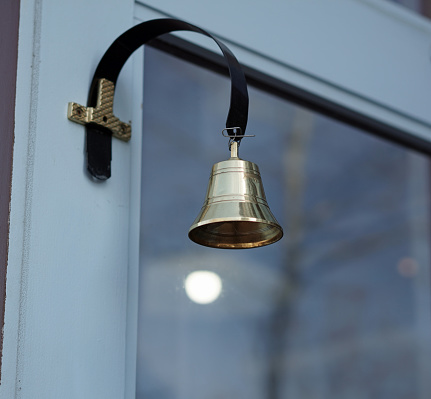 Retro doorbell on retail store entry door