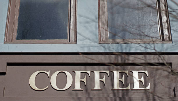 istock Coffee sign on modern building in city. 936176892