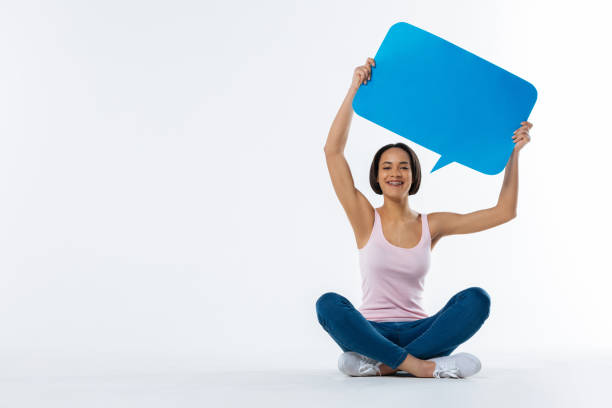 istock Cheerful nice woman holding a sign up 936177040