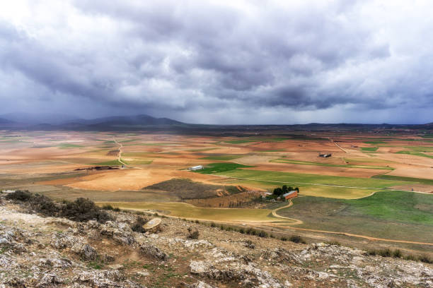 farmlands with stormy clouds above viewed from Windmills of Consuegra, Spain