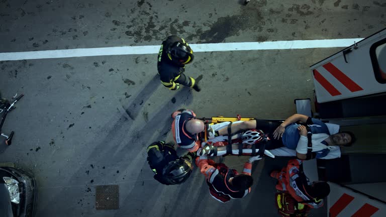 CS Firefighters helping the paramedics load the injured cyclist into the ambulance