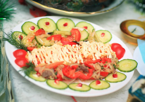 meat salad with pomegranate seeds at the Christmas table.photo with copy space.