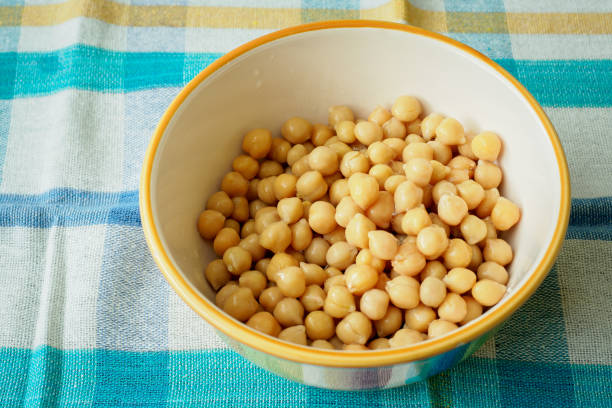istock Cooked chickpeas in ceramic bowl. Canned food, chickpea on bowl. 936193608