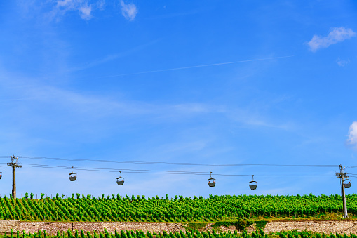 An Cable car floats over vineyards as a tourist attraction at the famous wine growing area Rheingau, Germany.