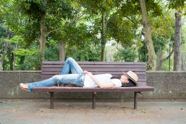 istock A woman taking a nap on the bench 936194682