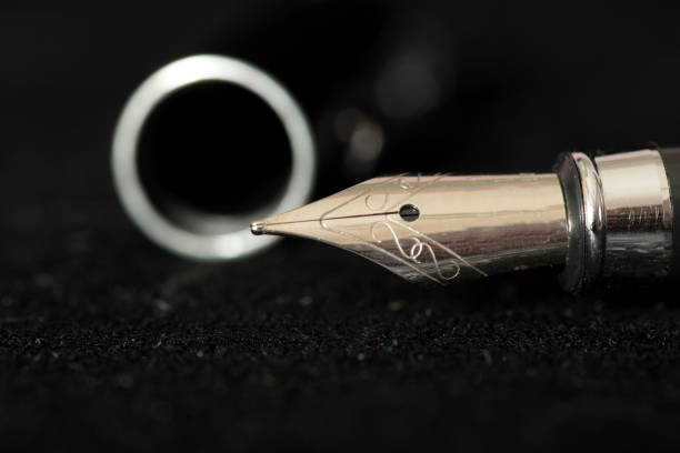 istock An elegant fountain pen on a black background 936195090